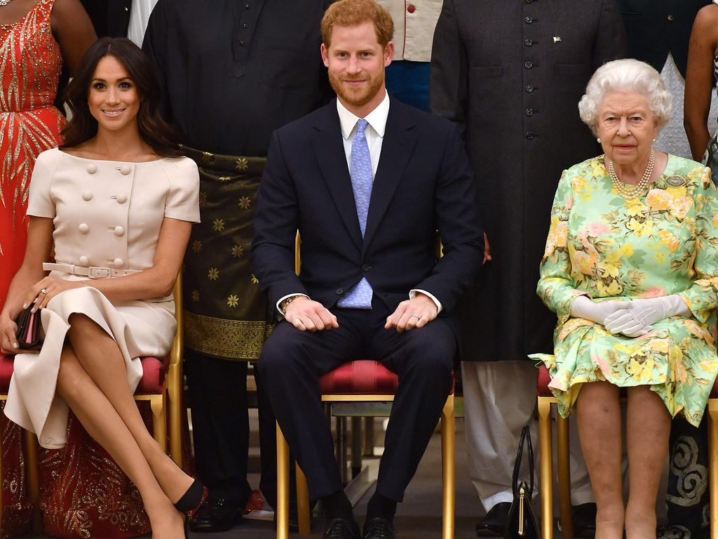 Meghan Markle, Prince Harry and the Queen. Picture: AFP