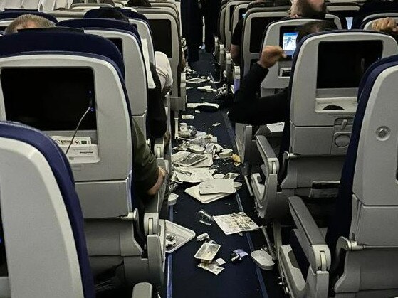Belongings were left strewn across the aisle after the plane encountered turbulence. Picture: Twitter