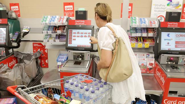 A customer uses a self-serve checkout at Coles in Erina. Picture: Mark Scott