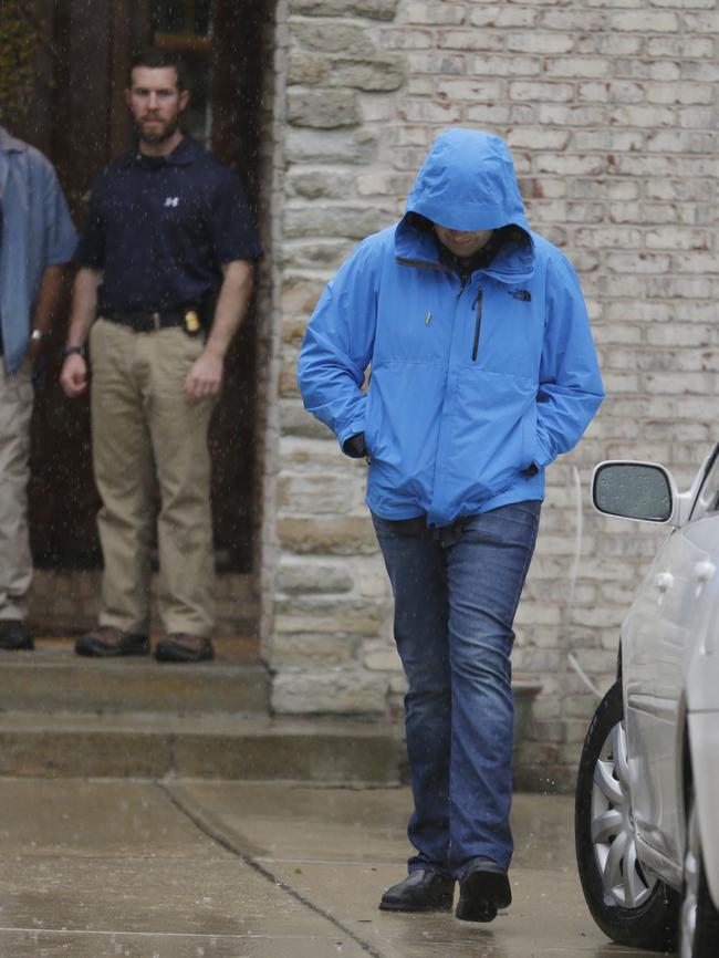 Jared Fogle walks to a waiting car as he leaves his home on Tuesday.