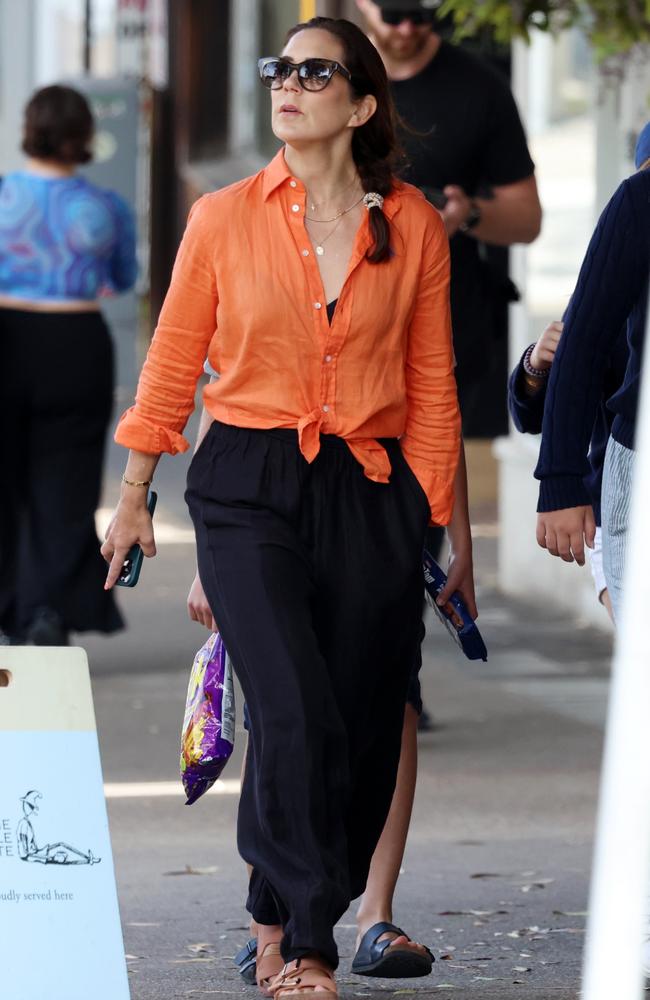 The homegrown princess looked chic in a bright orange shirt loosely tied up at her waist. Picture: Matrix Media Group.