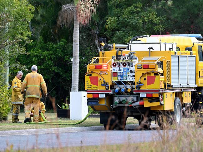 Firefighters extinguish spot fires at Landsborough on the Sunshine Coast. Picture: John Gass/NCA NewsWire