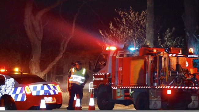 Police and an RFS appliance near the Buxton fire grounds last night. Picture: Steve Tyson