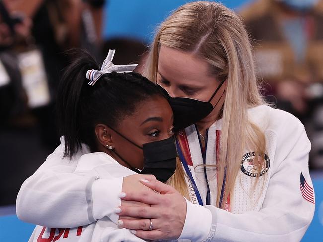 Simone Biles is embraced by coach Cecile Landi during the Women's Team Final in Tokyo. Picture: Ezra Shaw/Getty Images