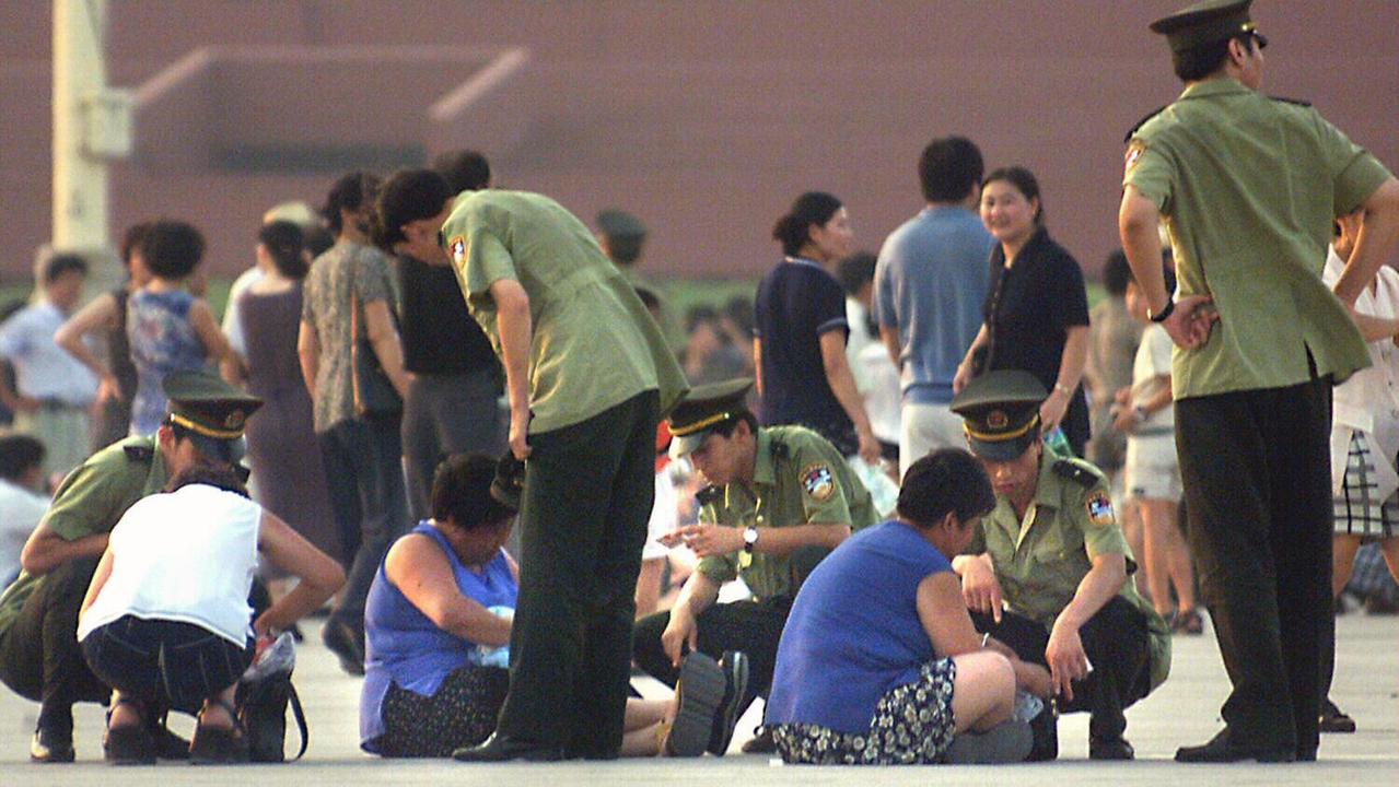 A photograph taken in 1999 when the Falun Gong crackdown began shows Chinese police arresting several women, suspected of being Falun Gong.