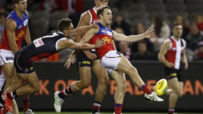 Lincoln McCarthy (centre) clears under pressure from Luke Dunstan during Brisbane’s win over St Kilda last week. Picture: AAP Image/Daniel Pockett