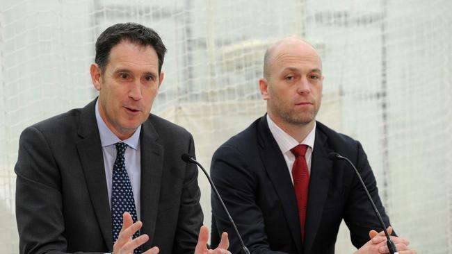 Cricket Australia CEO James Sutherland (L) and Australian Cricketers' Association CEO Alistair Nicholson attend a press conference in Melbourne on August 3, 2017. Australia's bruising and protracted cricket pay dispute was finally resolved on August 3 with players and management agreeing on a new "in-principle" deal, ensuring upcoming series against Bangladesh, India and England can go ahead. / AFP PHOTO