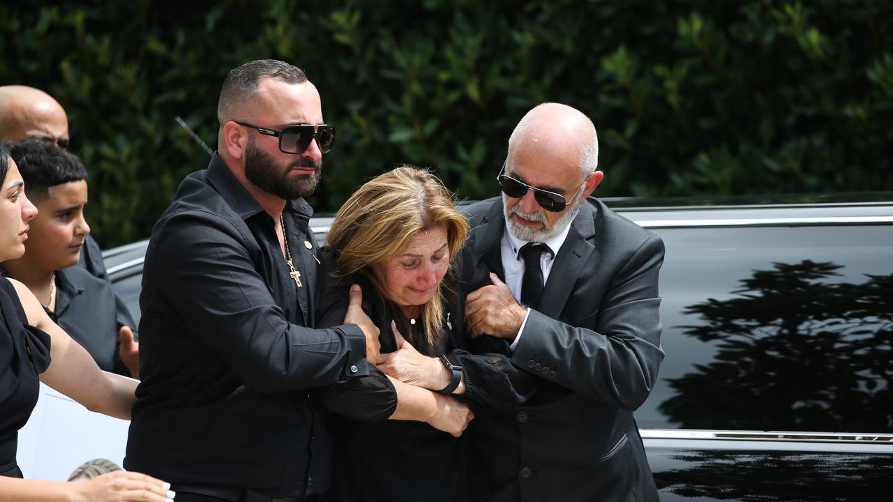 Mrs Tadros’ mother, Rita Jaja, breaks down as she is helped into the church. Picture NCA Newswire / Gaye Gerard