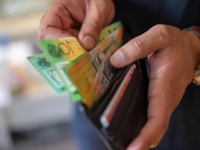 a male taking money out of the valet.