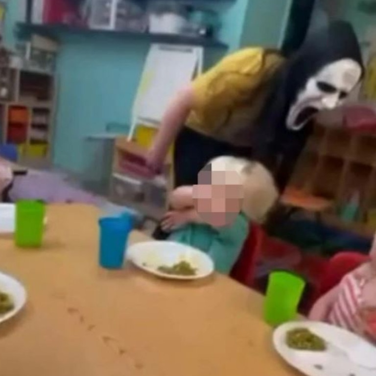 The masked worker appears to lean over and shout in the faces of the frightened children. Picture / Reddit