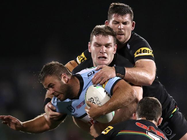 Wade Graham of the Sharks is caught in a Penrith tackle. Picture: Matt King/Getty Images)