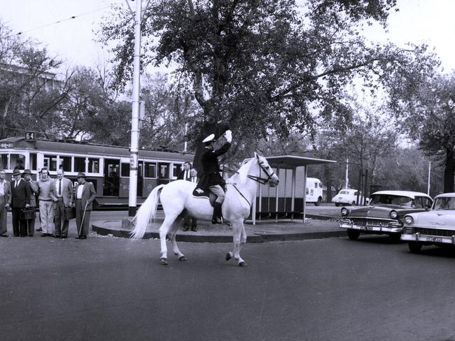 A mounted policeman directs traffic in St Kilda Road, near the former Royal Victorian Institute of the Blind, in the early 1960s. Picture: HWT Library