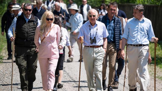 The King walks down a street in the village of Valea Zalanului, Romania. Picture: AFP