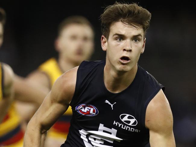 MELBOURNE, AUSTRALIA - JUNE 27:Paddy Dow of the Blues handballs  during the round 15 AFL match between the Carlton Blues and the Adelaide Crows at Marvel Stadium on June 27, 2021 in Melbourne, Australia. (Photo by Darrian Traynor/Getty Images)