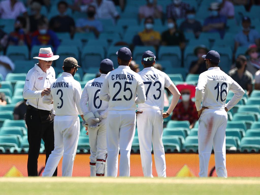 Indian players look towards a section of the SCG crowd.