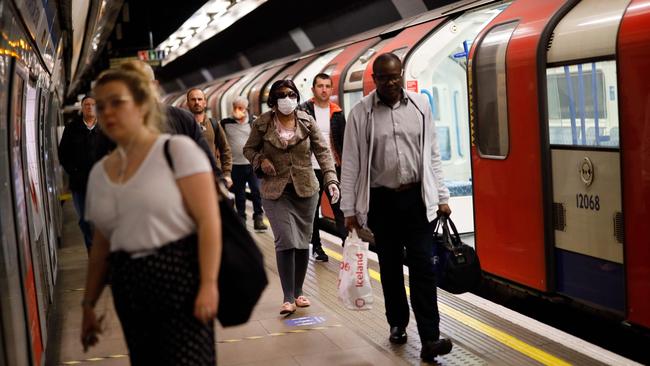 Commuters walk along a platform at a London tube station. Picture: AFP