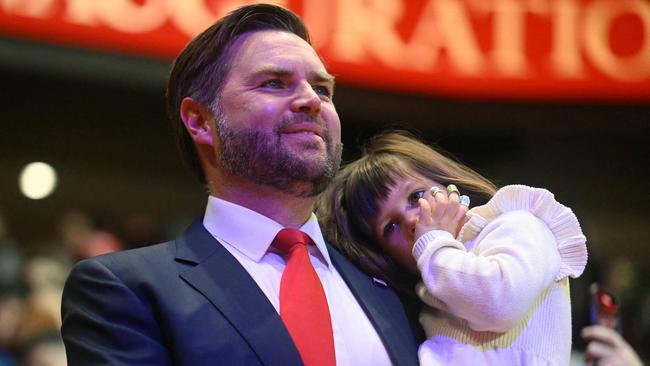 US Vice President J.D. Vance holds his daughter Mirabel as he arrives for the inaugural parade inside Capital One Arena, in Washington, DC, on January 20, 2025. (Photo by Jim WATSON / AFP)