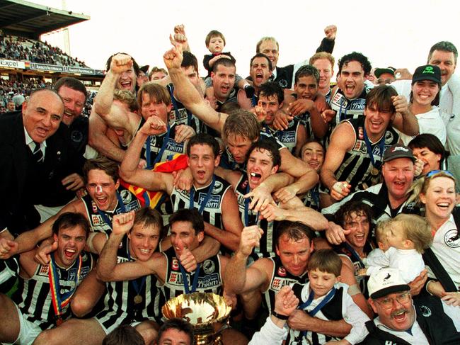 Darryl sitting behind the premiership cup after captaining Port to the 1998 SANFL flag.