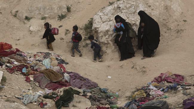 Women and their children who left the besieged Islamic State-held village of Baghouz, Syria. Picture: AP