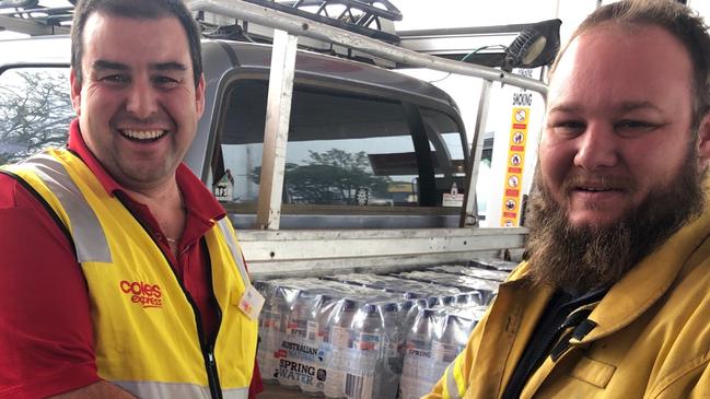 Coles site manager Taree Ben Elliot donating to Lansdowne Bush Fire Brigade. Picture: supplied