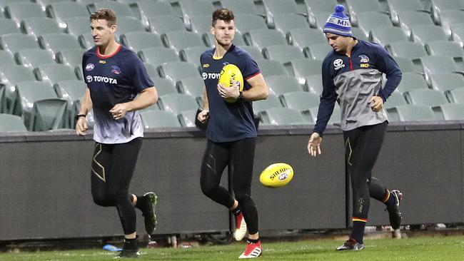 Adelaide Crows Josh Jenkins, Bryce Gibbs and Darcy Fogarty run laps of the Adelaide Oval. Picture SARAH REED