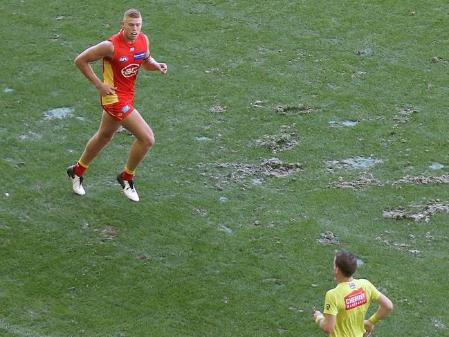 AFL Round 1. 24/03/2019. St Kilda vs Gold Coast Suns at Marvel Stadium.  Divots in the Marvel Stadium surface infront of the players interchange benches    . Pic: Michael Klein.