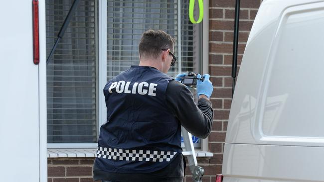 Police at what is believed to be the home of Dominic Perre in June. Picture: Roger Wyman