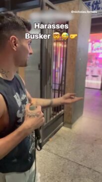 Busker threatens heckler during street performance