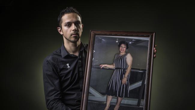 Arman Abrahimzadeh holds a photograph of his mother, domestic violence victim Zahra Abrahimzadeh.