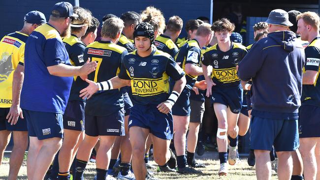 Bond Uni run onto the ground. Brothers v Bond Uni in the Colts 1 game at Crosby road. Saturday May 29, 2021. Picture, John Gass