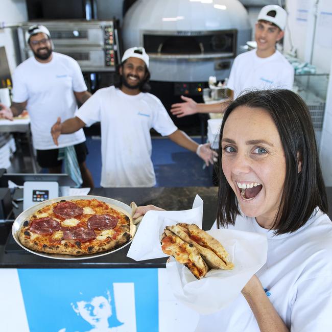 Roma Driscoll holds a pizza a portafoglio and The Goomah pizza at newly opened Francesca's at Glenelg with co-owners Aman Takher, Nilavan Baskaran and Aiden O'Sullivan. Picture: Mark Brake