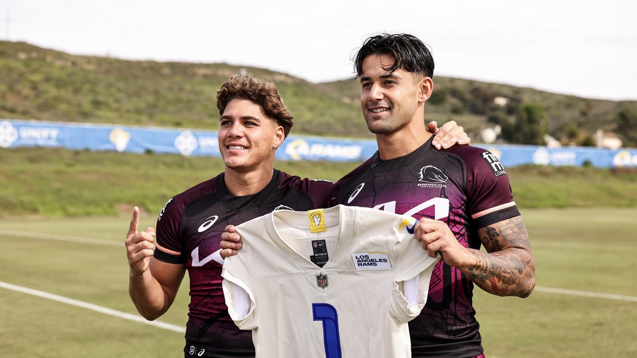 Reece Walsh and Jesse Arthars pose for a photo with a Los Angeles Rams jersey. Photo by Michael Owens/Getty Images.