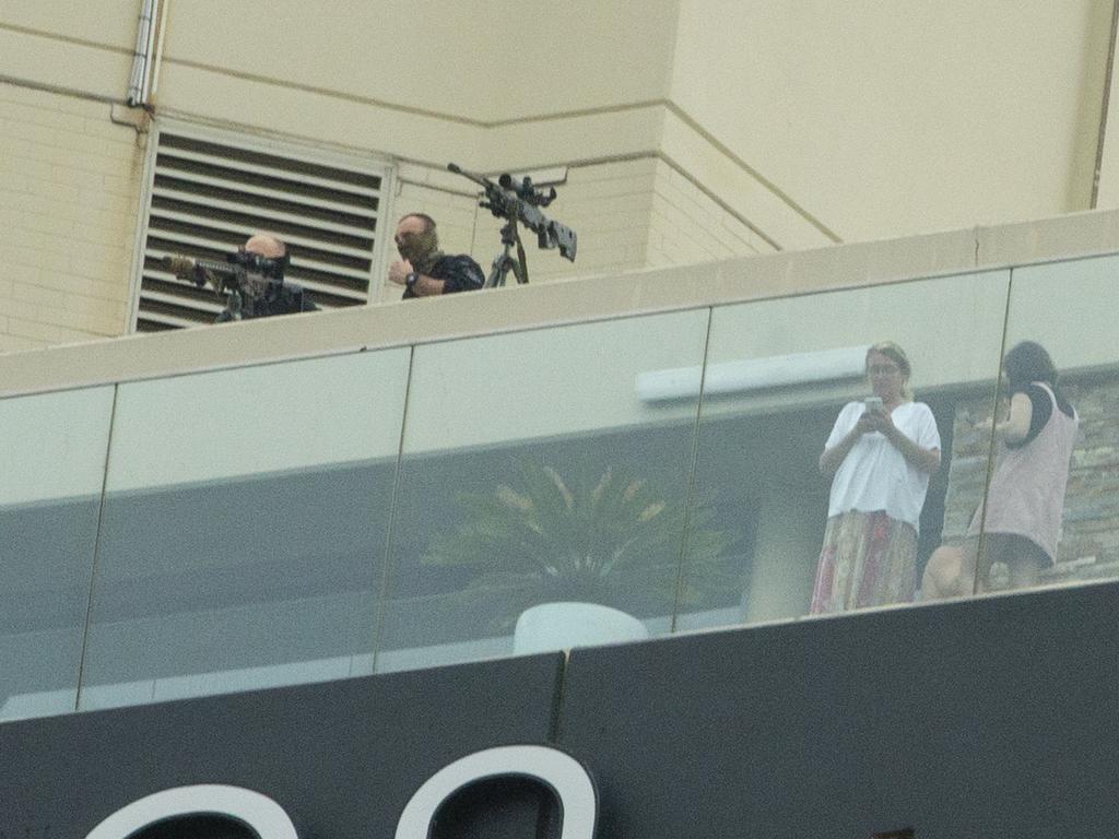 Sniper police are stationed on the top of a nearby hotel.