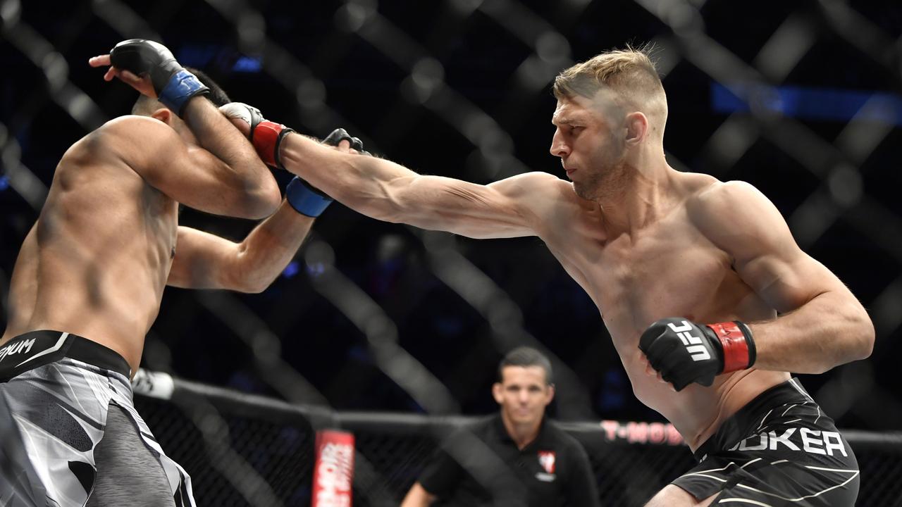 LAS VEGAS, NEVADA – SEPTEMBER 25: (R-L) Dan Hooker of New Zealand punches Nasrat Haqparast of Germany in their lightweight fight during the UFC 266 event on September 25, 2021 in Las Vegas, Nevada. (Photo by Chris Unger/Zuffa LLC)