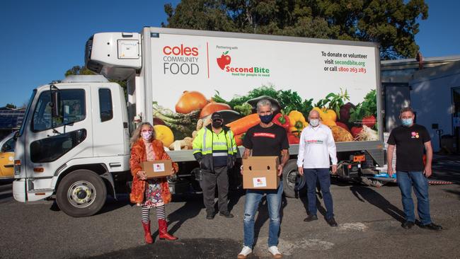 Craig Foster (C) at Addi Road Emergency Food Relief Hub in Marrickville with Addi Road CEO Rosanna Barbero, Coles driver Michael, SecondBite chairperson Julian Martin and Food Pantry manager Damien Moore. Picture: Chris Pavlich Photography