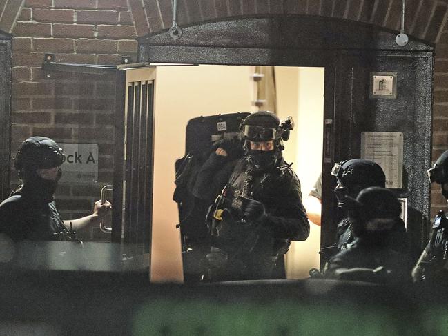 Armed police officers work at a block of flats off Basingstoke Road in Reading after an incident at Forbury Gardens park in the town centre of Reading, England. Picture: Steve Parsons/AP