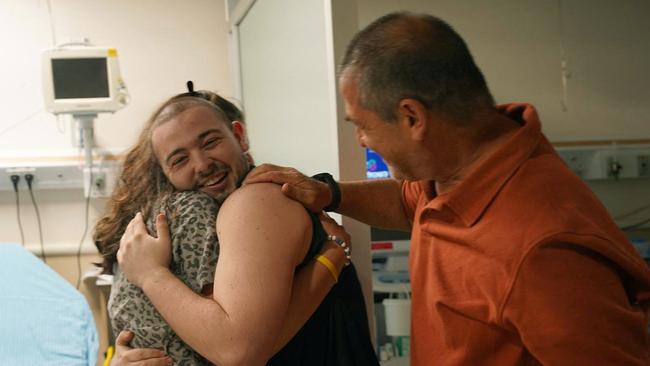 Almog Meir Jan, 22-years-old, being huggedat the Sheba Tel-HaShomer Medical Centre. Picture: AFP