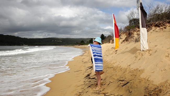 Swimmer Cathy Hoeben at Ocean Beach. The high tide was so high lifeguards placed the flags in the sand dunes (AAP image/ Mark Scott)