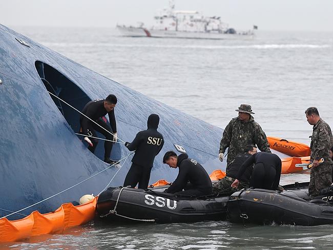 Searching for answers ... South Korean rescuers on board the capsized ferry at sea some 20 kilometres off the island of Byungpoong in Jindo. Picture: Yonhap