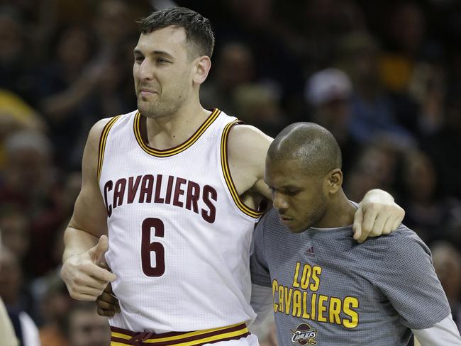 Cleveland Cavaliers' Andrew Bogut (6) is helped off the court by James Jones in the first half of an NBA basketball game against the Miami Heat, Monday, March 6, 2017, in Cleveland. (AP Photo/Tony Dejak)