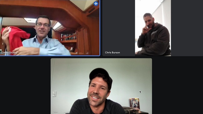 A screenshot of Glenn Druery holding up a Labor Party red shirt during a video meeting with Chris Burson and Heston Russell.