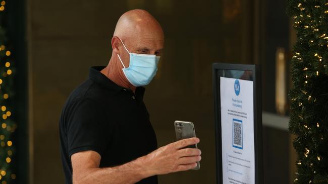 QR check-in codes and wearing a face mask are now a thing of the past in most in retail and office settings. Picture: Getty