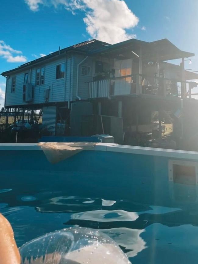 The family home, before the fire, viewed from the backyard pool.