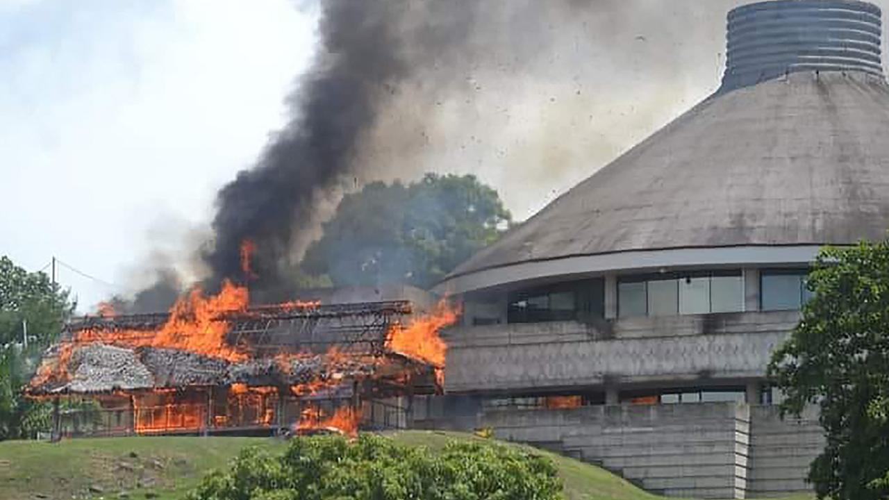 Protesters burned next to the parliament building in Honiara. Picture: Charley Piringi/AFP