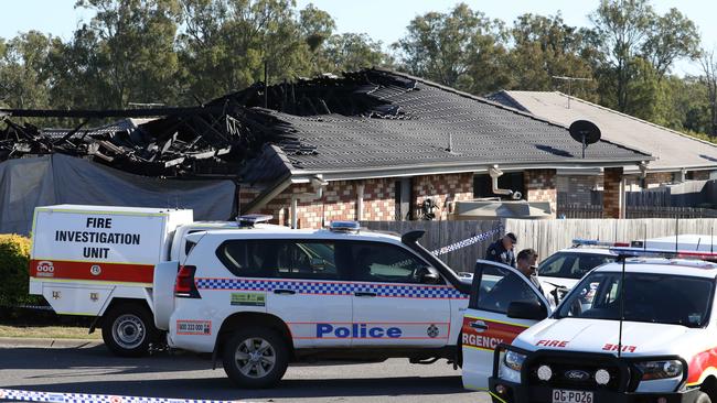 Investigators at the scene of the fatal house fire. Picture: Annette Dew