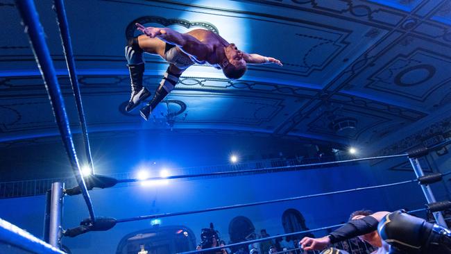 Grand slam: Slex performs a “moonsault” – a backflip off the ropes, to land on his supine opponent. Picture: Owen Jones