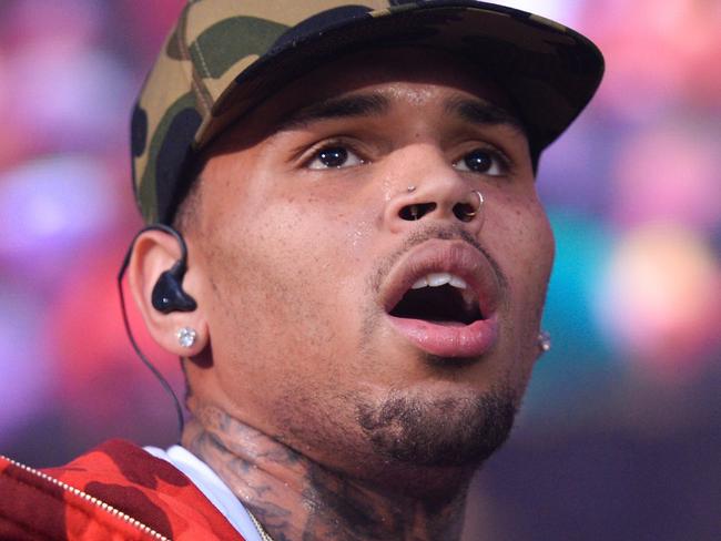 FILE - In this June 7, 2015, file photo, rapper Chris Brown performs at the 2015 Hot 97 Summer Jam at MetLife Stadium in East Rutherford, N.J. Authorities said officers responded to singer Brown's Los Angeles home early Tuesday, Aug. 30, 2016, after a woman called police seeking assistance. (Photo by Scott Roth/Invision/AP, File)