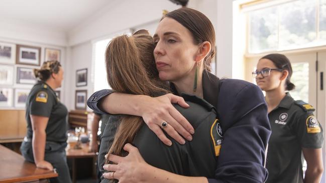 Jacinda Ardern, right, hugs a first responder in Whakatane, New Zealand after a volcanic island in New Zealand erupted, killing multiple people. Picture: AP