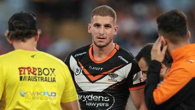 Adam Doueihi of the Wests Tigers walks from the field injured. (Photo by Mark Metcalfe/Getty Images)