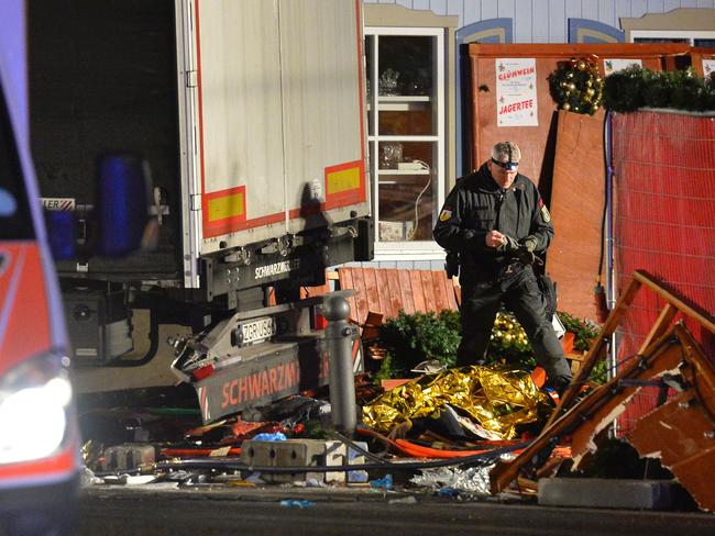 A policeman inspects the truck that crashed into the Christmas market. Picture: AFP